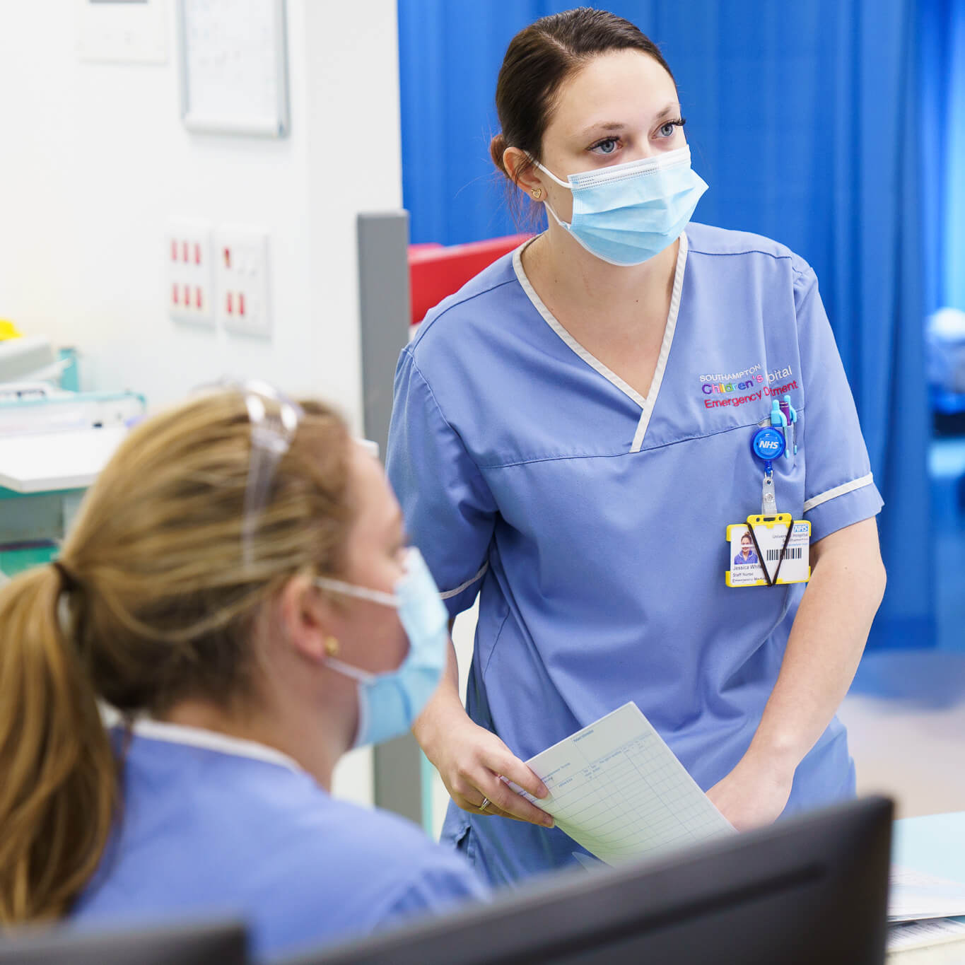 Two female healthcare workers in discussion