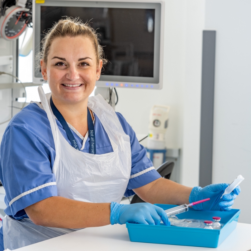 Female medic in lab preparing syringe