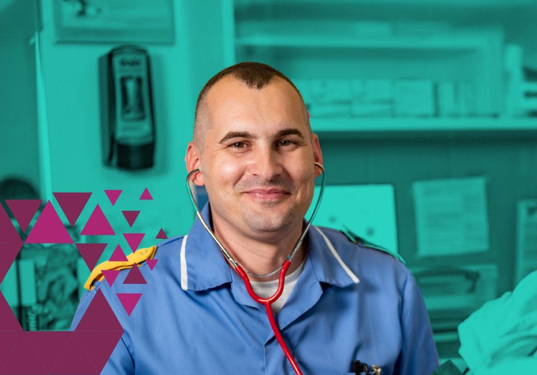 Smiling male nurse in blue scrubs with stethoscope