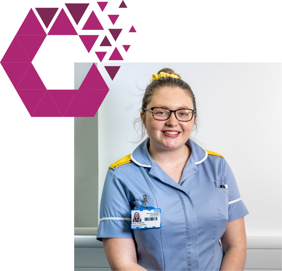 Smiling nurse in blue and white uniform with glasses, standing by geometric design