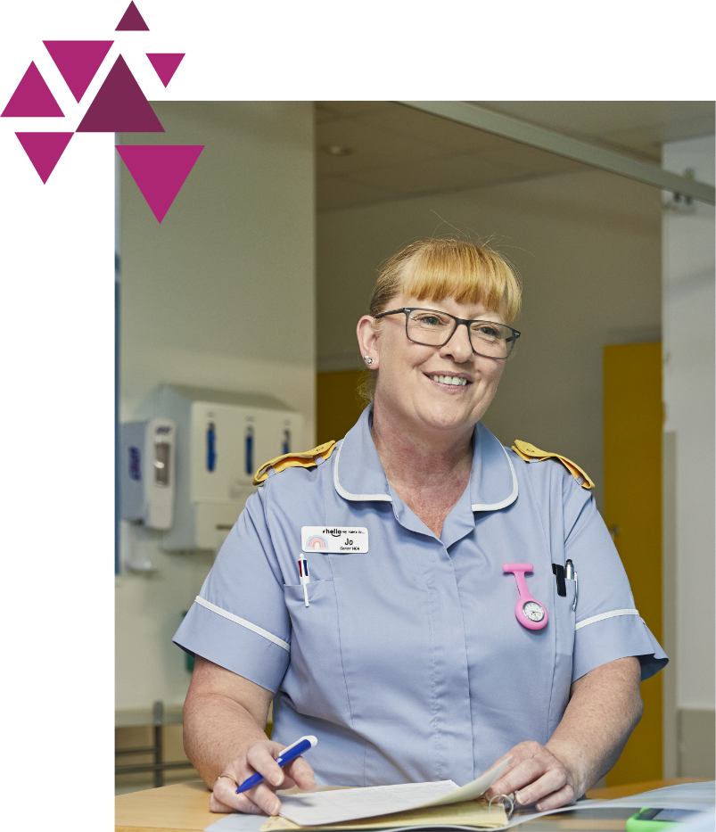 Smiling nurse with glasses and clipboard at hospital counter