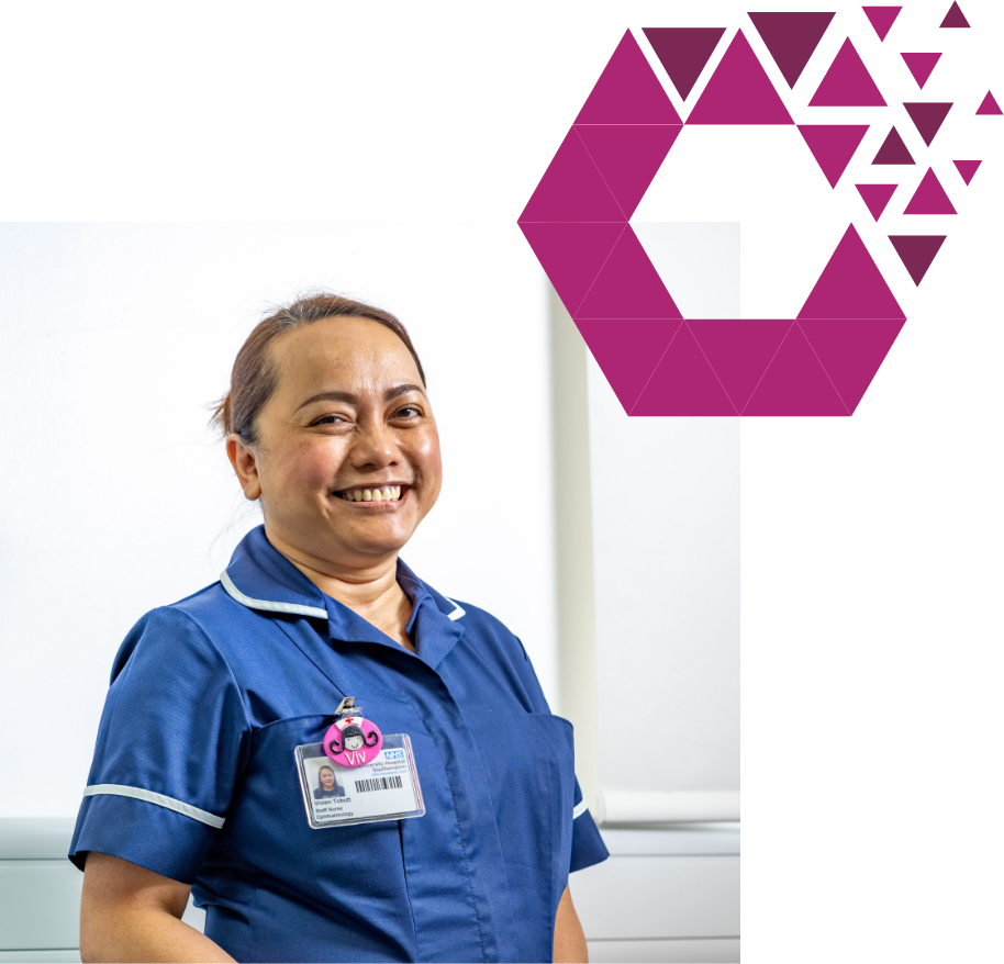 Smiling nurse in blue scrubs with ID badge, standing near purple hexagon design