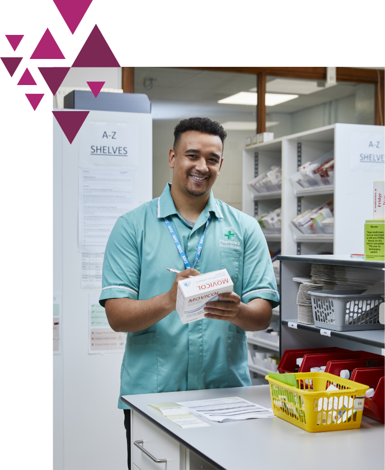 Smiling pharmacist holding medication and prescription in a pharmacy