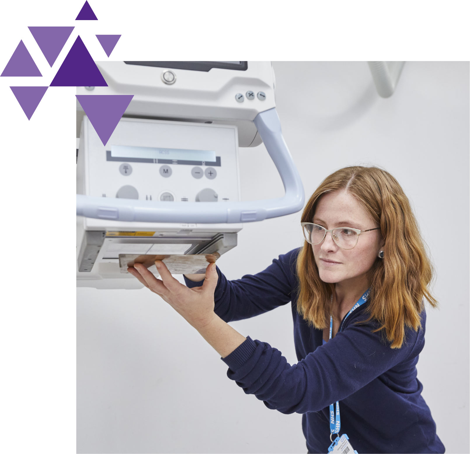Female technician adjusting a large medical device