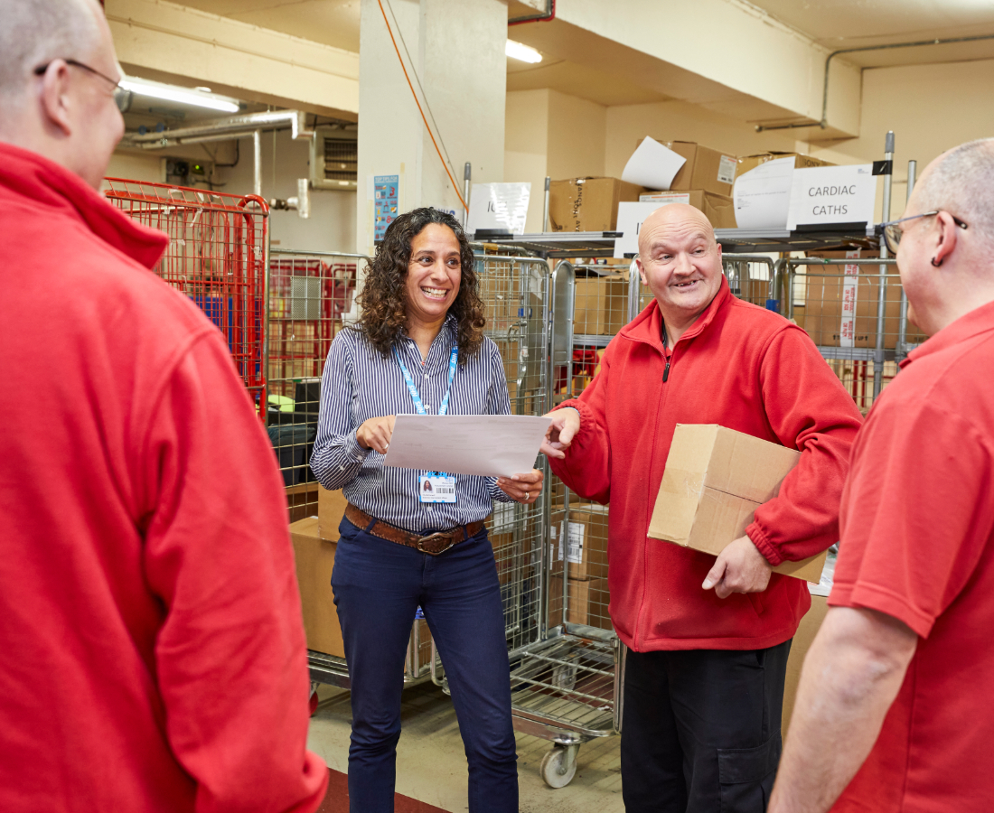 Coworkers smiling and interacting in a warehouse