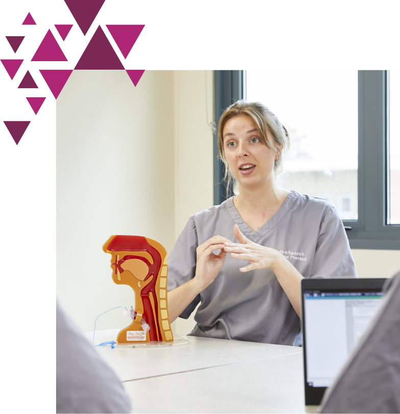 Healthcare professional teaching with respiratory model in classroom